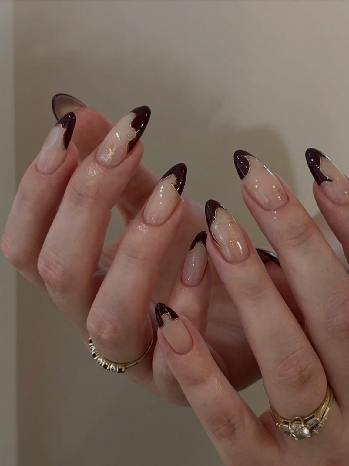 Dark brown French tip Korean gel almond nails with gold accents by Joy Nail Studio Vancouver